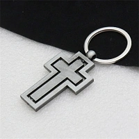 Metal keychain with a rotating cross
