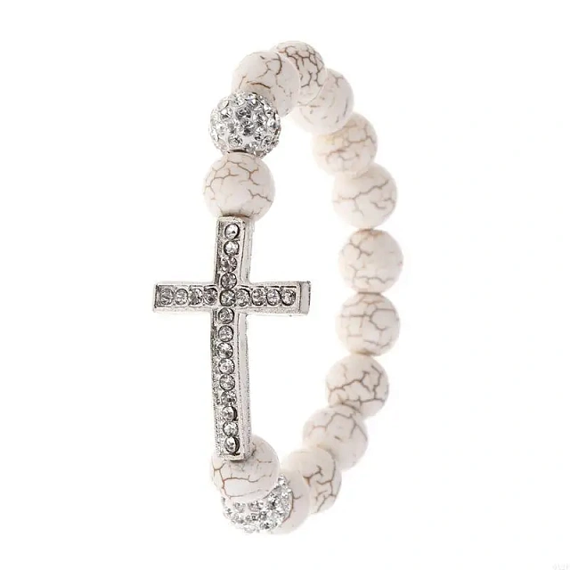 A white stone bracelet with a cross