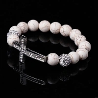 A white stone bracelet with a cross