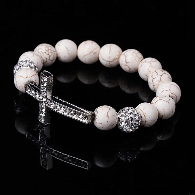 A white stone bracelet with a cross