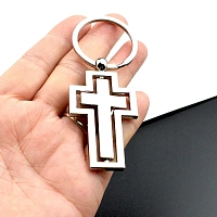 Metal keychain with a rotating cross